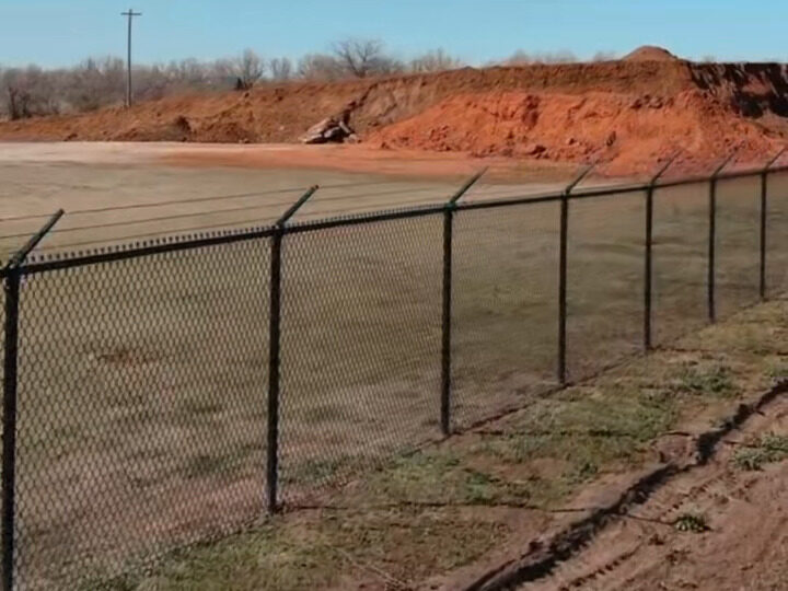 New black chain link fence installed by SWY Fencing