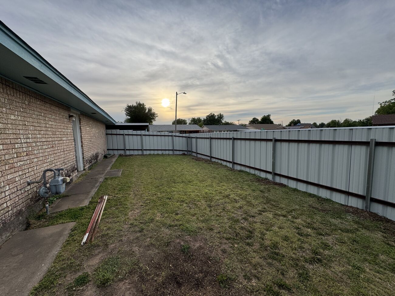 Steel panel fence at golden hour by SWY Fencing